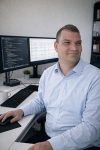 Lukas Paul Streiff at a workstation with code and operational systems